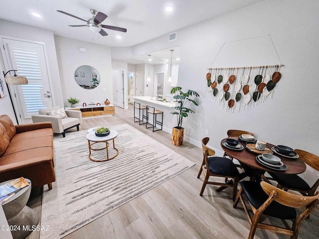 living room featuring light hardwood / wood-style floors and ceiling fan