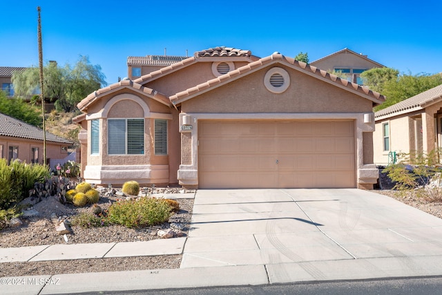 mediterranean / spanish-style home with a garage