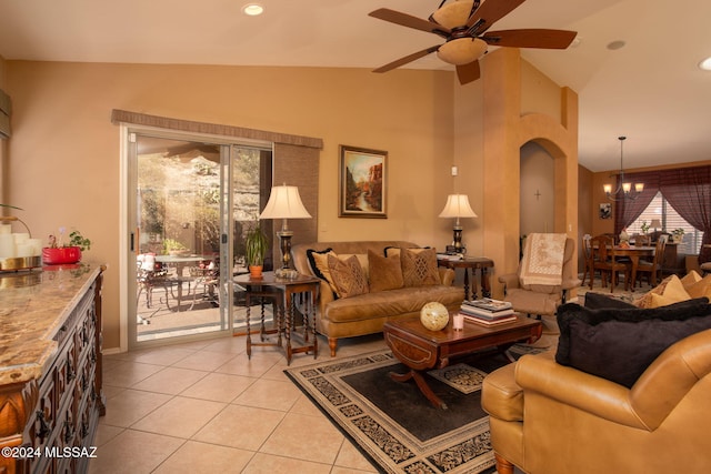 living room featuring light tile patterned floors, a healthy amount of sunlight, and vaulted ceiling