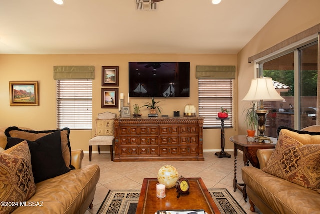 living room featuring light tile patterned flooring and vaulted ceiling