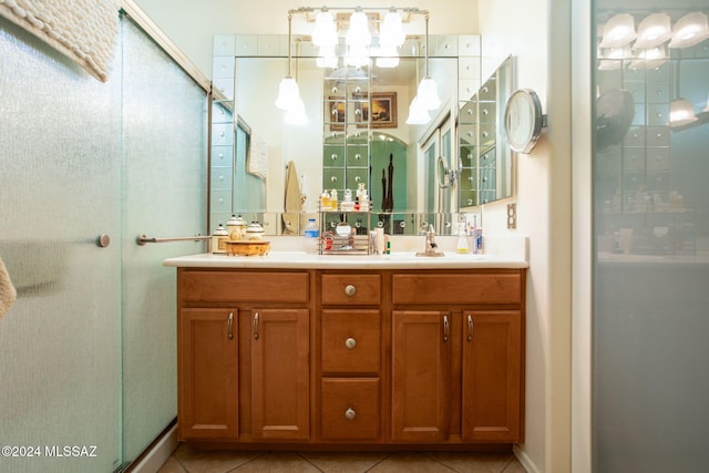 bathroom with vanity, tile patterned floors, and a shower with shower door