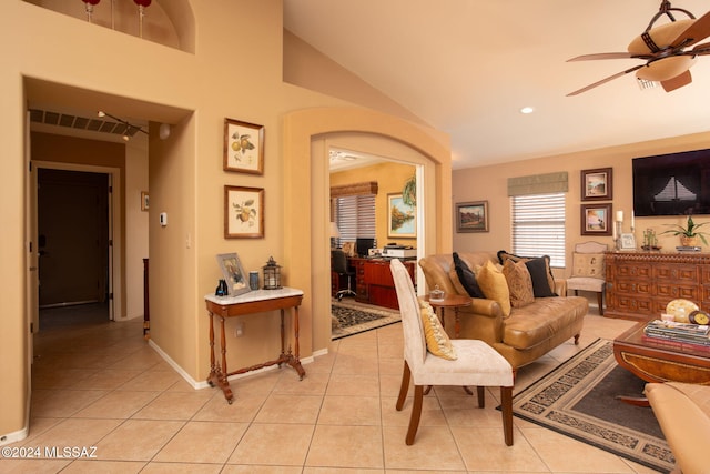 tiled living room with lofted ceiling and ceiling fan