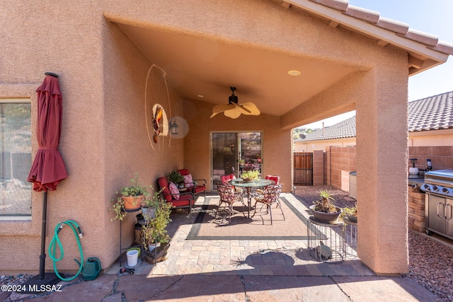 view of patio with grilling area and ceiling fan