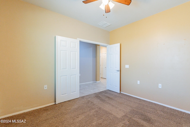 unfurnished bedroom with ceiling fan and light colored carpet