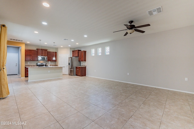 unfurnished living room with ceiling fan and light tile patterned floors