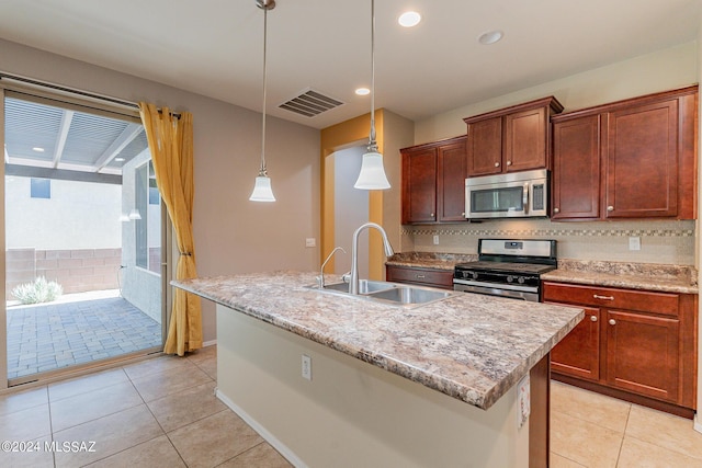 14031 E Troika St, Vail, AZ 85641 - kitchen with appliances with stainless steel finishes, light tile patterned floors, backsplash, a kitchen island with sink, and pendant lighting