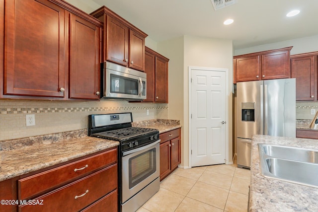 14031 E Troika St, Vail, AZ 85641 - kitchen featuring appliances with stainless steel finishes, tasteful backsplash, light tile patterned floors, light countertops, and recessed lighting