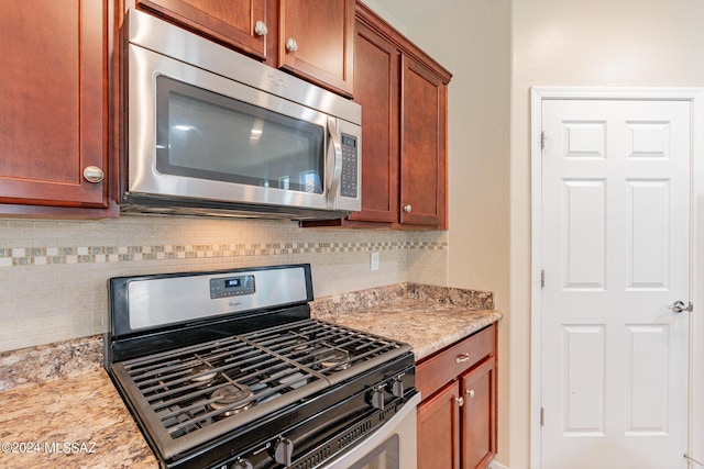 14031 E Troika St, Vail, AZ 85641 - kitchen with stainless steel appliances, backsplash, and light stone countertops
