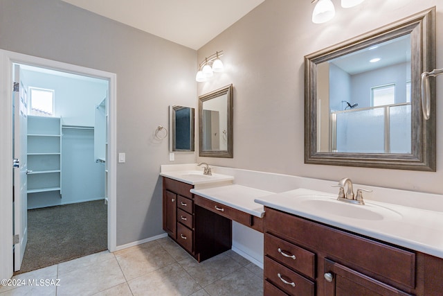 bathroom featuring tile patterned floors, vanity, a healthy amount of sunlight, and a shower with shower door