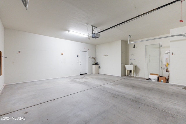 garage with a garage door opener, water heater, and sink