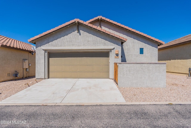 14031 E Troika St, Vail, AZ 85641 - view of front of property featuring a garage, stucco siding, concrete driveway, and a tiled roof