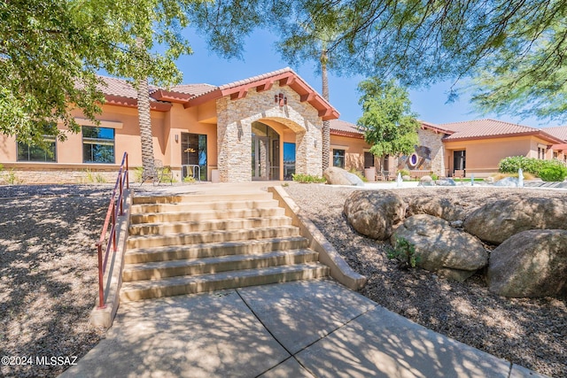 14031 E Troika St, Vail, AZ 85641 - mediterranean / spanish home featuring a tiled roof, stone siding, stucco siding, and stairs