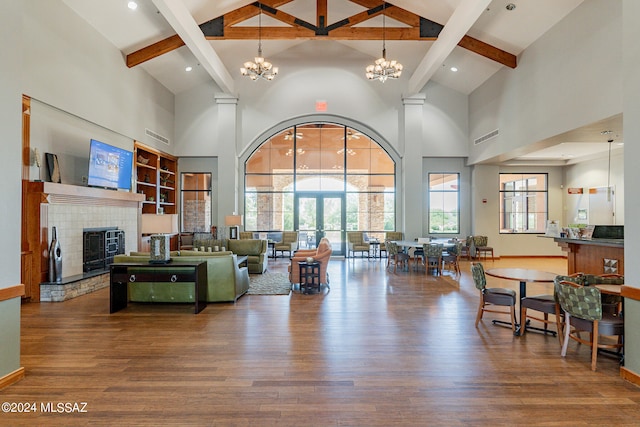 living room featuring hardwood / wood-style floors, high vaulted ceiling, and beam ceiling