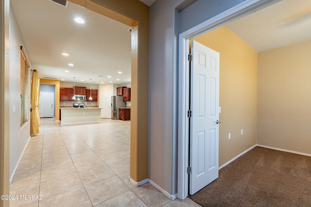 hall with light tile patterned flooring