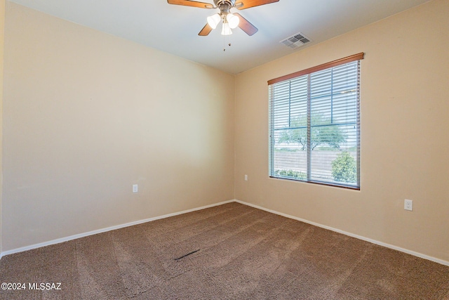 14031 E Troika St, Vail, AZ 85641 - spare room featuring dark colored carpet, healthy amount of natural light, and ceiling fan