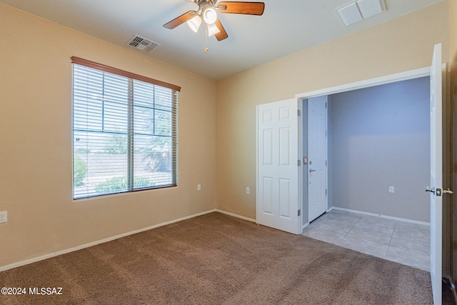 carpeted empty room featuring ceiling fan