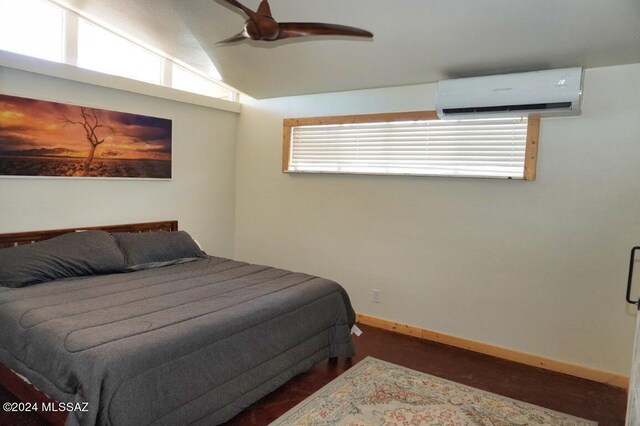 bedroom featuring lofted ceiling, a wall mounted AC, and ceiling fan