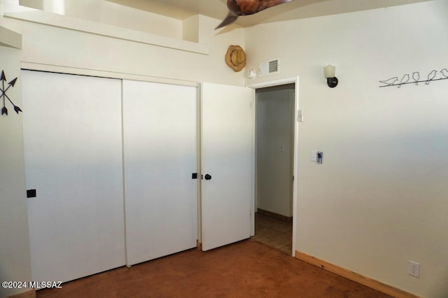 unfurnished bedroom featuring lofted ceiling and a closet