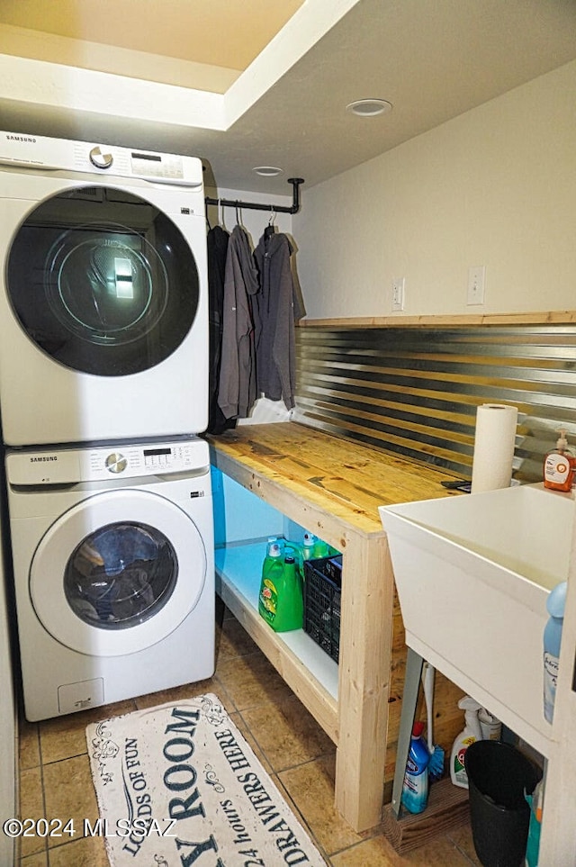 clothes washing area with stacked washer and clothes dryer