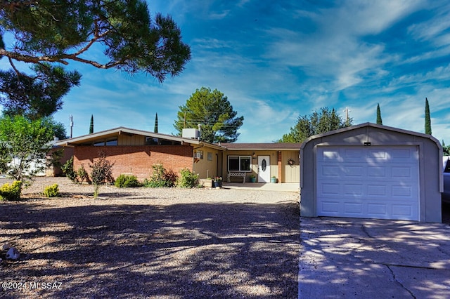 ranch-style home featuring an outbuilding and a garage