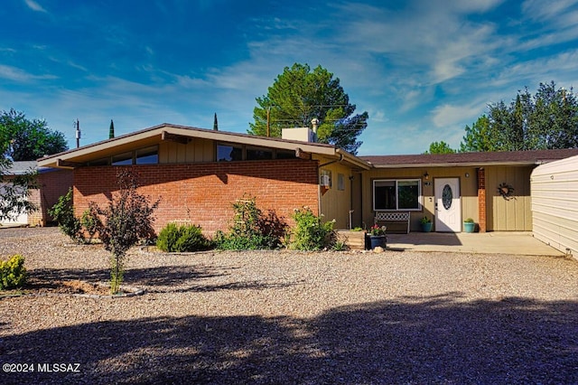 rear view of property featuring a patio area