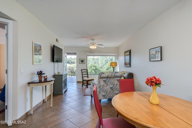 living room with ceiling fan, plenty of natural light, and tile patterned floors