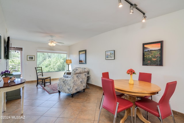 tiled dining area with rail lighting and ceiling fan