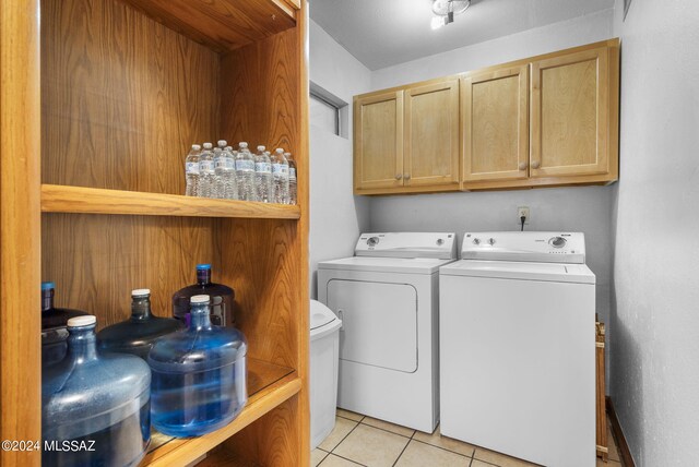 laundry room with light tile patterned floors and washer and dryer