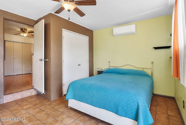 bedroom featuring ceiling fan, light tile patterned flooring, and a wall mounted AC