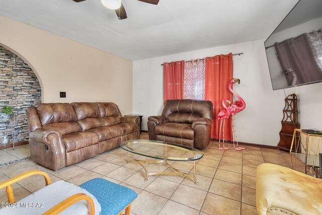 living room featuring ceiling fan and tile patterned flooring