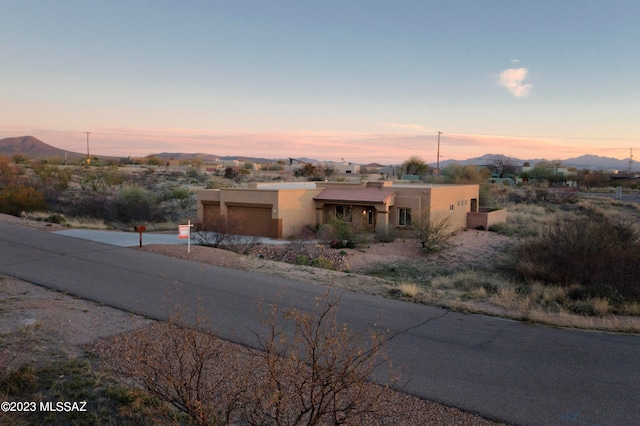 southwest-style home featuring a mountain view and a garage