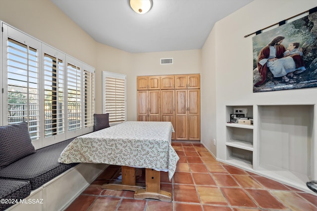 bedroom with light tile patterned flooring and a closet