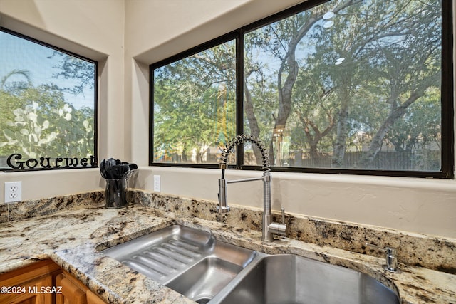 interior details with light stone countertops and sink