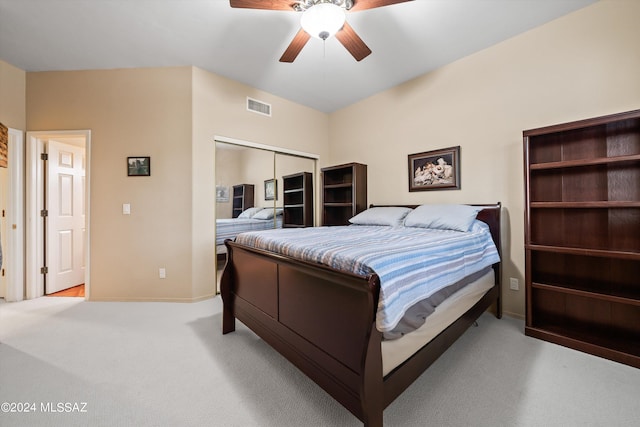 carpeted bedroom with ceiling fan and a closet