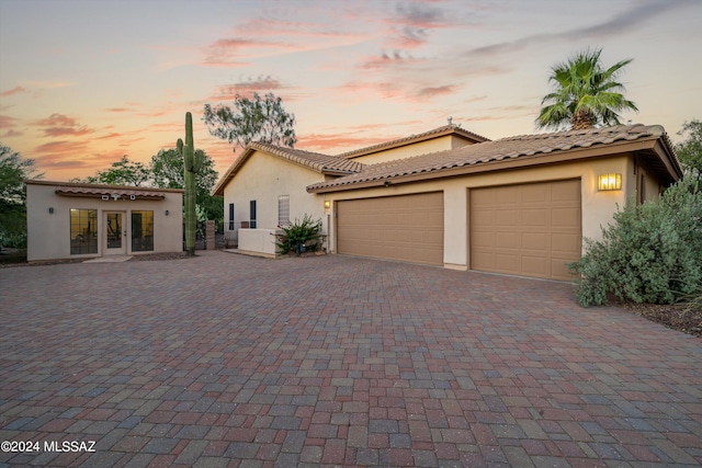 mediterranean / spanish-style house with a garage