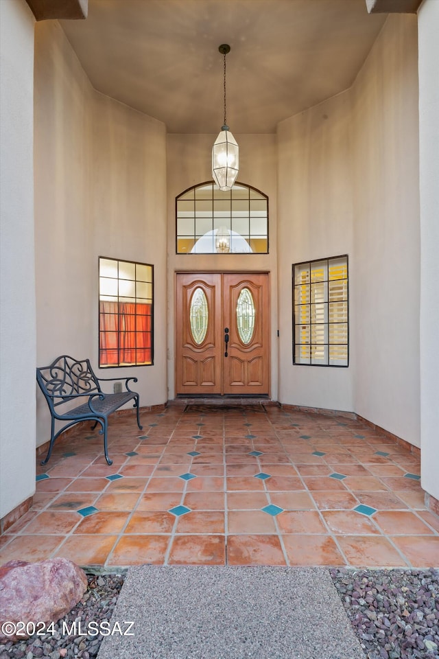 tiled foyer with a towering ceiling