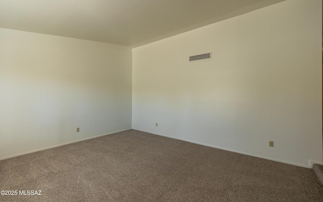 spare room featuring carpet flooring, baseboards, and visible vents