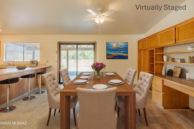 dining area with lofted ceiling and ceiling fan