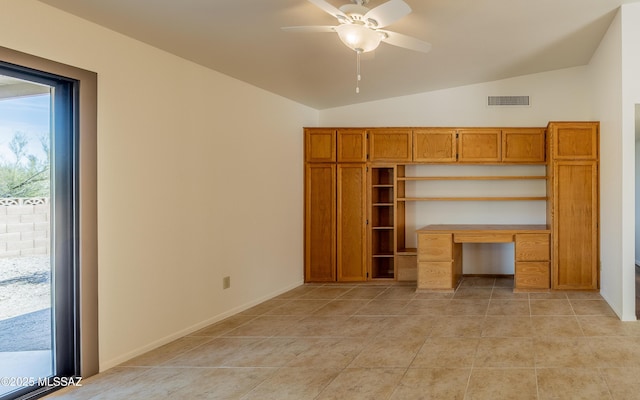 unfurnished bedroom with visible vents, baseboards, lofted ceiling, light tile patterned floors, and built in desk