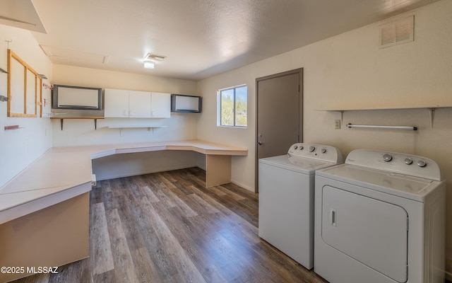 clothes washing area with laundry area, visible vents, independent washer and dryer, and dark wood-style flooring