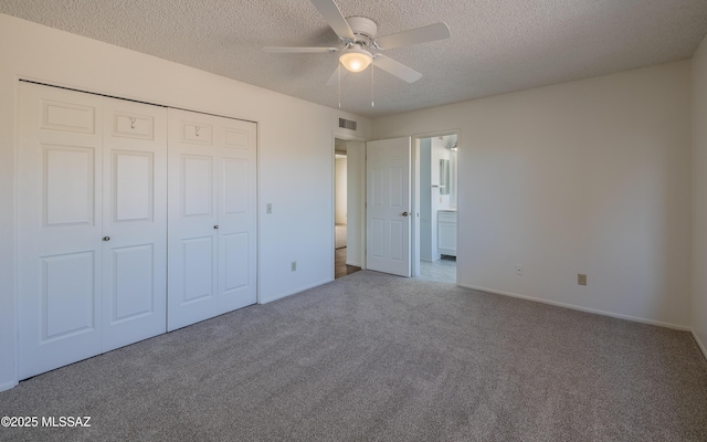 unfurnished bedroom featuring visible vents, baseboards, carpet, a closet, and a textured ceiling