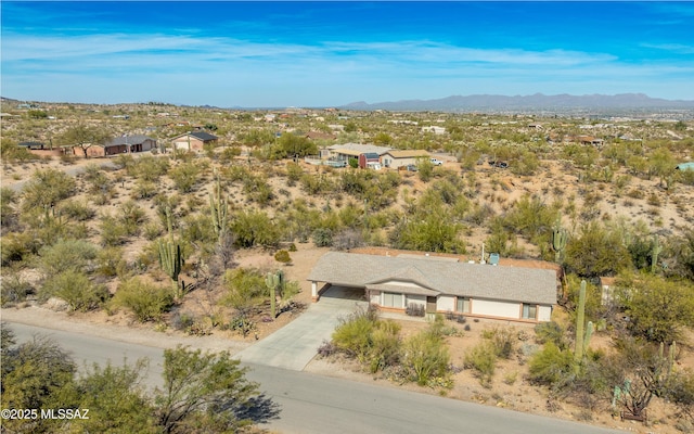 birds eye view of property with a mountain view and a desert view