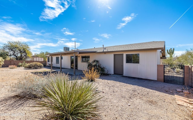 back of house featuring a gate, a patio area, and fence