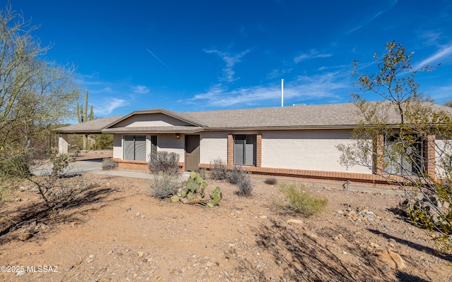 single story home with brick siding