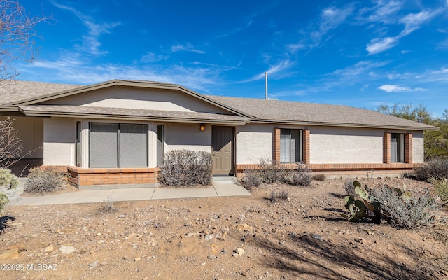 ranch-style house with brick siding and stucco siding