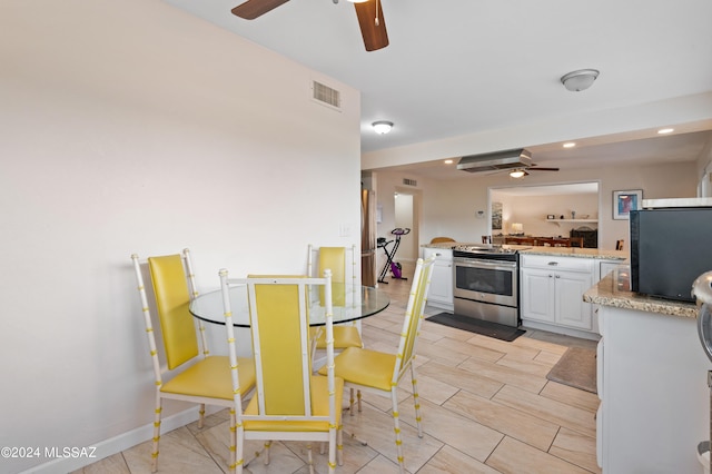 dining room featuring light hardwood / wood-style floors and ceiling fan