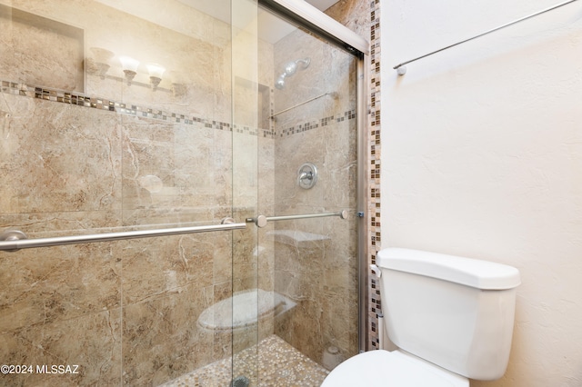 bathroom with walk in shower and toilet