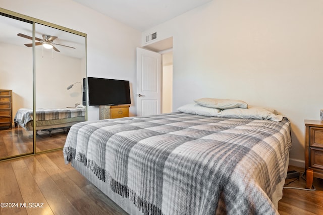 bedroom with ceiling fan, a closet, and hardwood / wood-style floors