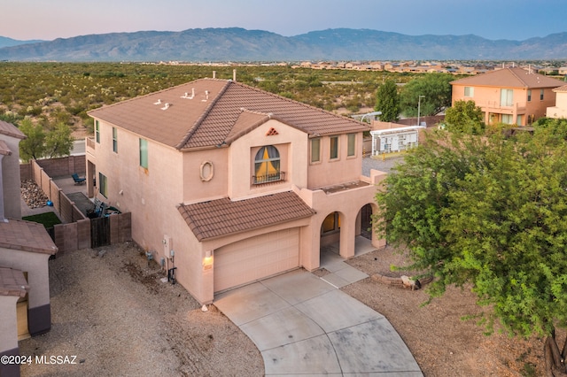 mediterranean / spanish-style house featuring a mountain view and a garage