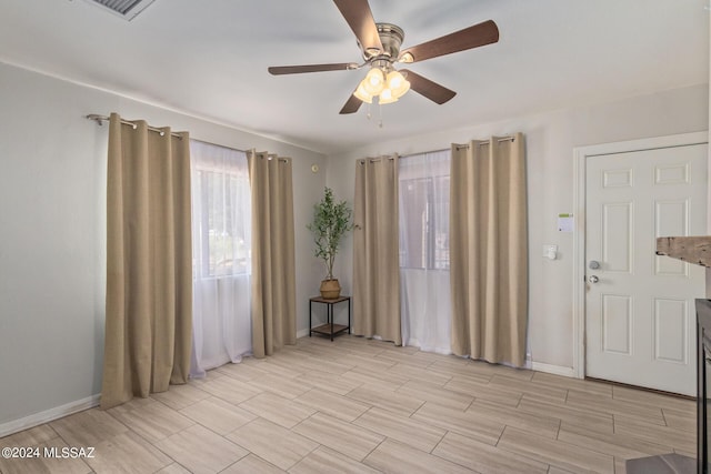 interior space with ceiling fan